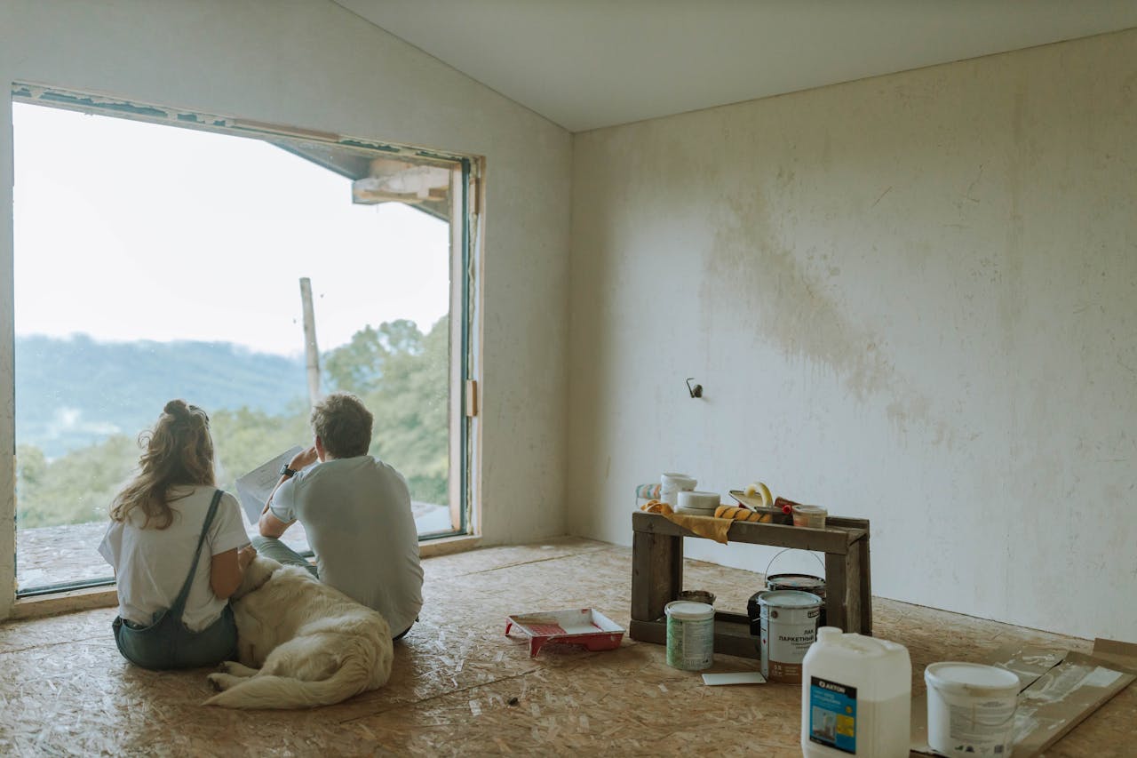 Backview of Couple sitting together with their Pet Dog